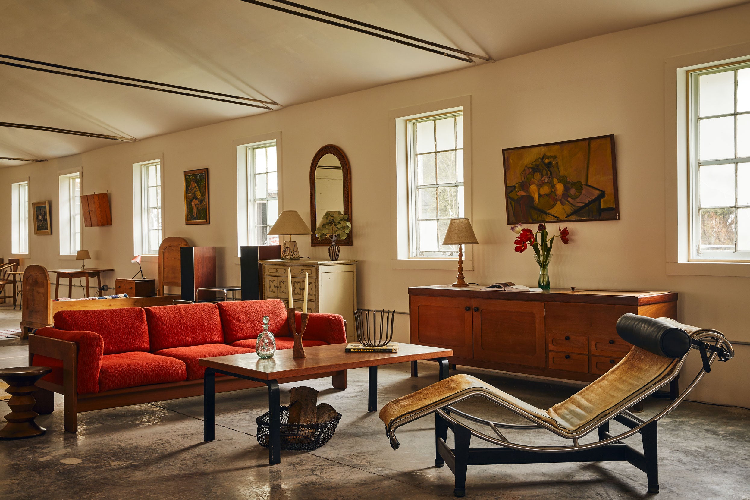 Living room with red sofa, wooden coffee table, and chaise lounge.
